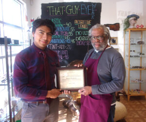 CCLP volunteer presents Certificate of Appreciation to supportive business owner